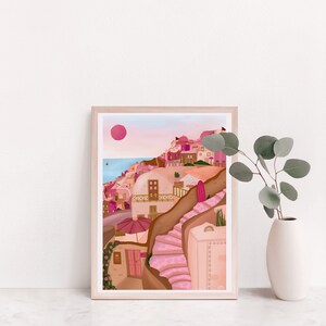 May include: A framed illustration of a pink and brown cityscape with a pink sun in the sky. The city is built on a hillside with a winding staircase leading up to the top.
