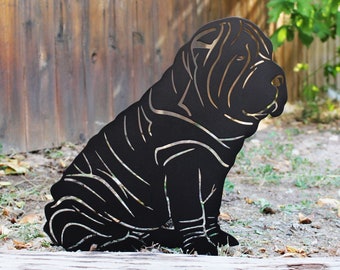 May include: Black metal silhouette of a Shar-Pei dog sitting with its legs crossed. The silhouette is cut out of metal and has a detailed design.