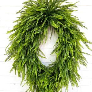 May include: A green artificial fern wreath, perfect for adding a touch of greenery to your home decor.
