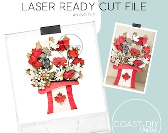 May include: Laser cut file for a Canadian themed flower pot. The pot is shaped like a hat with a Canadian flag on the front. The pot is surrounded by red, white, and blue flowers.