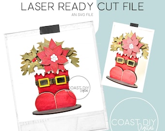 May include: A laser-cut SVG file design for a Christmas boot with a poinsettia flower and greenery on top. The boot is red with a brown base and black belts. The design is labeled "COAST DIY Digital".