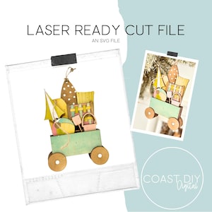 以下が含まれることがあります： 木製のビーチをテーマにしたカートのレーザーカットファイル。カートは明るい緑色で塗装され、木製の車輪が付いています。ビーチパラソル、ボール、バスケットなど、ビーチアクセサリーが満載です。「LASER READY CUT FILE」と「AN SVG FILE」の文字が見えます。