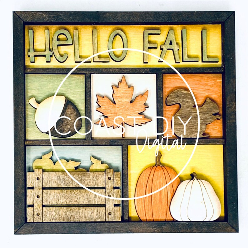 May include: A wooden framed wall decor with the words "Hello Fall" in a yellow, orange, and brown color scheme. The frame contains six squares with various fall-themed images, including an acorn, a maple leaf, a squirrel, a pumpkin, a bushel of leaves, and a pumpkin.