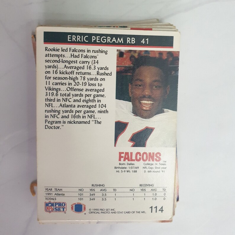 May include: A 1992 Pro Set football card featuring Erric Pegram, a running back for the Atlanta Falcons. The card is numbered 114 and includes Pegram's statistics for the 1991 season. The card is in good condition with minor wear.