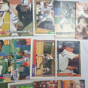 May include: A collection of vintage sports trading cards featuring various players from different teams. The cards are in various colors, including green, blue, red, and white. The cards feature photos of the players and their names and positions.