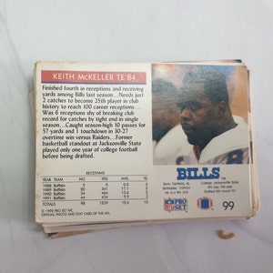 May include: A 1992 Pro Set NFL trading card featuring Keith McKeller, a tight end for the Buffalo Bills. The card is blue and white with a photo of McKeller in his Bills uniform. The card number is 99.