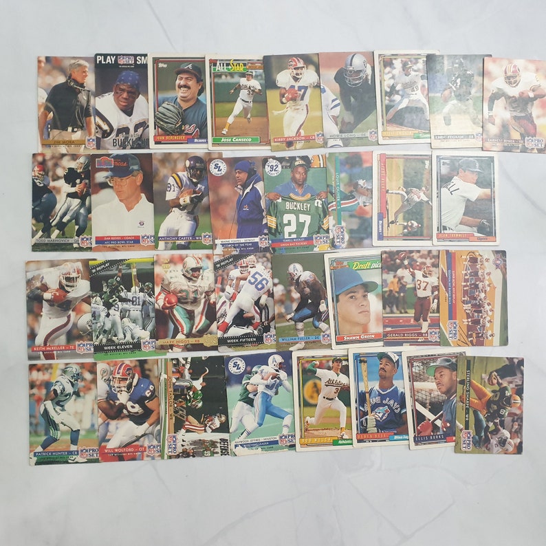 May include: A collection of 25 vintage football trading cards featuring players from different teams. The cards are in various colors, including red, blue, green, and yellow. The cards feature player names, team logos, and player statistics.