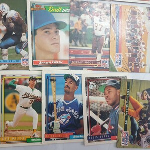 May include: A collection of vintage sports trading cards featuring baseball and football players. The cards are in various colors and feature player names and team logos. The cards are in good condition and would be a great addition to any sports memorabilia collection.