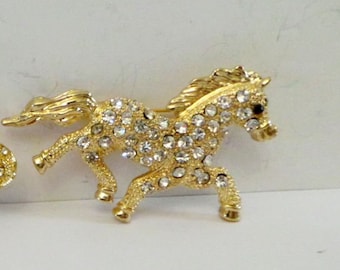Gilded vintage brooch Inlaid with zircon stones in the shape of a horse