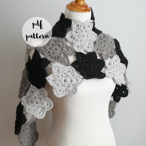 May include: A grey, black and silver crochet scarf with a star pattern. The scarf is draped over a white mannequin. The text "pdf pattern" is written in a circle on the image.