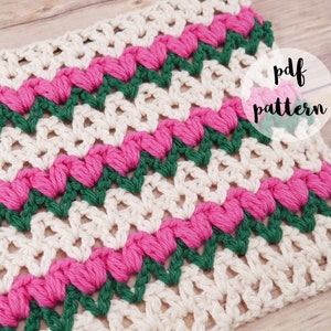 Può includere: Un quadrato all'uncinetto con un motivo ripetuto di cuori rosa e zigzag verdi su sfondo crema. Le parole "pdf pattern" sono in un cerchio bianco. L'articolo è fatto a mano.