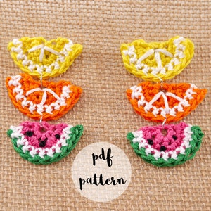 May include: Crochet pattern for a set of fruit-shaped earrings. The earrings are made of yellow, orange, and green yarn and feature a lemon, orange, and watermelon design. The pattern is available as a PDF download.