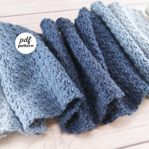 May include: A collection of folded, textured crochet items in varying shades of blue, from light to dark. The image includes a white circle with the text "pdf pattern". The Fiber Flux logo is visible in the bottom right corner.