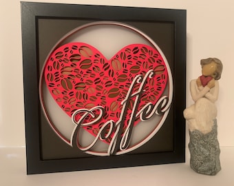 May include: A framed 3D wall art piece with a red heart shape filled with coffee bean designs and the word "Coffee" in a stylized font.