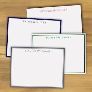 May include: Four white stationery note cards with different colored borders. The top card has a pink border and the text "STEVEN ROBERTS". The second card has a navy blue border and the text "ANDREW KURTZ". The third card has a green border and the text "SCOTT MITCHELL". The bottom card has a gray border and the text "CARTER WILLIAMS".