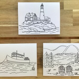 May include: Three black and white line drawings on white paper. The first drawing is of a lighthouse on a rocky island. The second drawing is of a boat on the water. The third drawing is of a lake scene with two chairs.