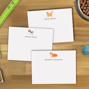 May include: Three white note cards with different dog breeds illustrated on each. The top card has a golden retriever, the middle card has a beagle, and the bottom card has a corgi. Each card has a name written below the dog. The top card says "Olivia Parker", the middle card says "Andrew Kurtz", and the bottom card says "Elizabeth Thompson".