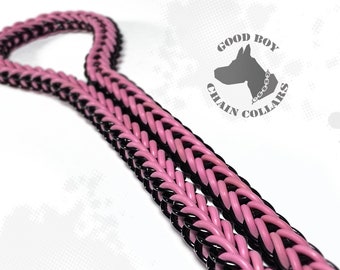 May include: A pink and black braided chain collar for a dog. The collar is made of two strands of braided cord, one pink and one black. The collar is shown on a white background.