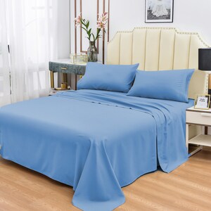 May include: A light blue bed sheet set with two pillowcases. The sheet is made of a soft, comfortable fabric and is wrinkle-resistant.