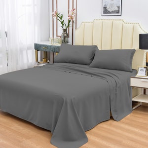 May include: A gray bed sheet set with two pillowcases. The sheet is made of a soft, comfortable fabric and is wrinkle-resistant.