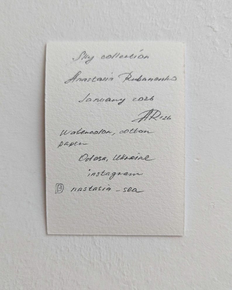 Pu&ograve; includere: Un appunto scritto a mano su carta ruvida. Il testo recita: "Sky collection, Anastasia Rubanonks, January 2026, Watercolor, cotton paper, Odosa, Ukraine, instagram @nastasia-sea."