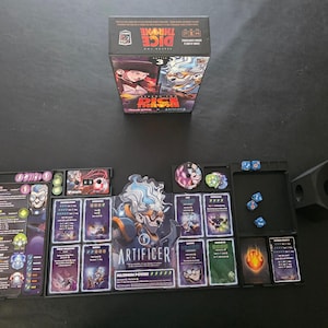 May include: A board game set, "Dice Throne: Season 1 ReRolled", with a box displaying character art and various game components. The set includes cards, dice, tokens, and a dice tray, arranged on a dark surface. The game's theme is fantasy.