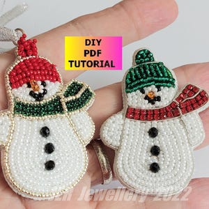 May include: Two beaded snowman ornaments with red and green hats and scarves. DIY PDF TUTORIAL is written on a pink background.