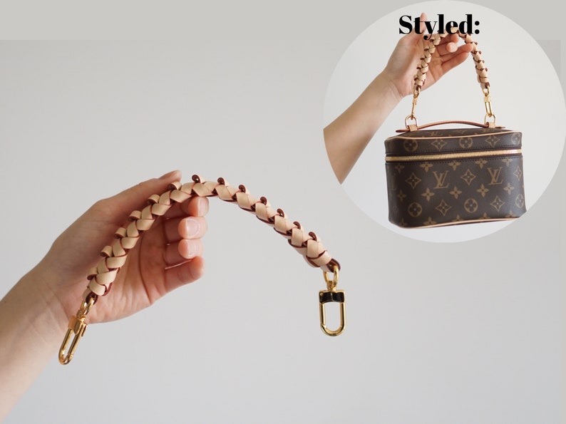 May include: A braided leather strap with gold hardware. The strap is designed to be used as a replacement handle for a handbag.