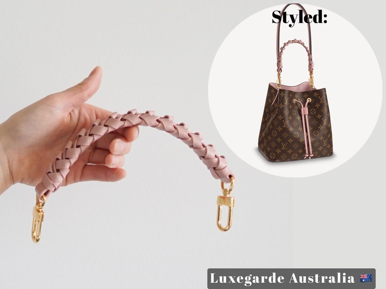 May include: Pink braided leather handbag strap with gold hardware.  The strap is shown being held in a hand.  The text "Styled:" is visible in the background.