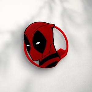 May include: Red and black 3D printed pin featuring a close-up of Deadpool's face.