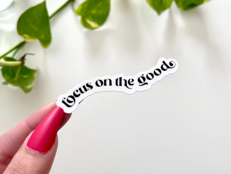 May include: White sticker with black text that reads "focus on the good" in a cursive font.