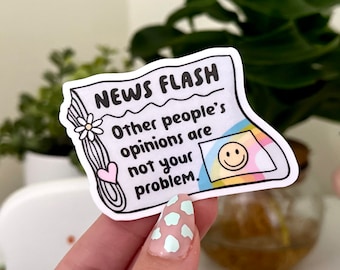 May include: A white sticker with a newspaper headline that reads "NEWS FLASH" and the text "Other people's opinions are not your problem." A smiling face is in a rainbow-colored box.