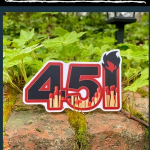 May include: A red and black sticker with the number 451 in large black font. The number is surrounded by a red outline. The number 1 is on fire and the numbers 4 and 5 are surrounded by a group of red-tipped matches.