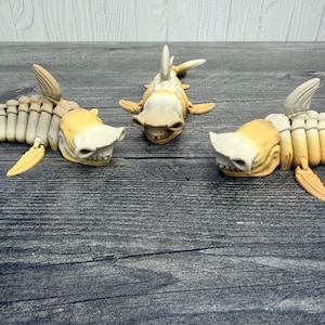 May include: A set of three ceramic nesting bowls in shades of blue, green, and white. The bowls feature a speckled glaze and a simple, modern design. The largest bowl is approximately 6 inches in diameter.