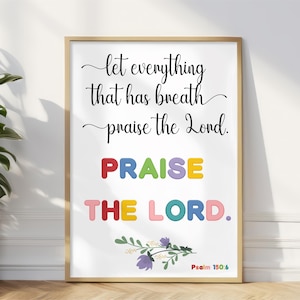 May include: A framed print with the words "let everything that has breath praise the Lord." The word "PRAISE" is in colorful block letters, and "THE LORD" is also in colorful block letters. Psalm 150:6 is at the bottom.