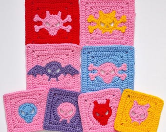 May include: A collection of colorful, crocheted squares with various skull and crossbones, bat, and devil designs. The squares are in shades of red, pink, yellow, blue, and purple, perfect for a unique craft project.