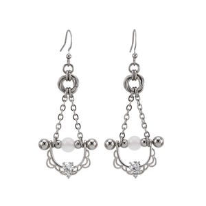 May include: A pair of silver-toned earrings with a dangling design. Each earring features a chain, a white bead, and a clear gemstone. The earrings have a decorative, openwork design at the bottom and a hook for the ear.