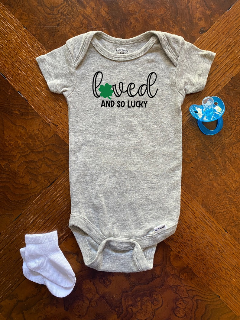 St Patty/'s Day Onesie Cute Holiday Onesie Lucky Baby Onesie Loved And So Lucky St Patrick/'s Day Gerber Baby Onesie