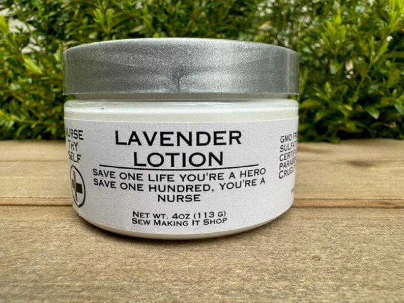May include: A white jar of lavender lotion with a silver lid. The label reads "Lavender Lotion" and includes the text "Save one life you're a hero, save one hundred, you're a nurse." The jar is 4 oz (113 g) and is made by Sew Making It Shop.