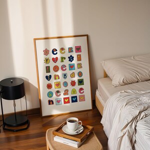May include: A framed print with a white background and colourful letters and symbols arranged in a grid pattern. The letters spell out "See You Because I Love You".