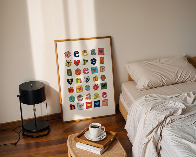 May include: A framed print with a white background and colourful letters and symbols arranged in a grid pattern. The letters spell out "See You Because I Love You".