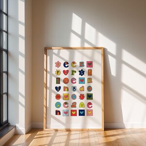 May include: A framed print with a white background and colourful letters and symbols arranged in a grid. The letters spell out "seek first the kingdom of god".