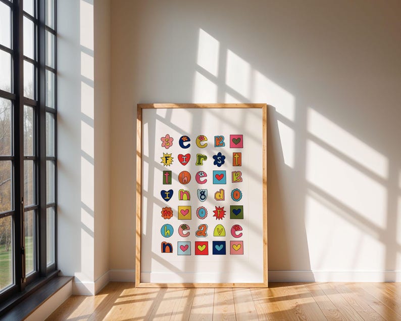 May include: A framed print with a white background and colourful letters and symbols arranged in a grid. The letters spell out "seek first the kingdom of god".