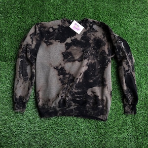 May include: A black and gray tie-dye sweatshirt with a white tag that says "Shop Small Business".