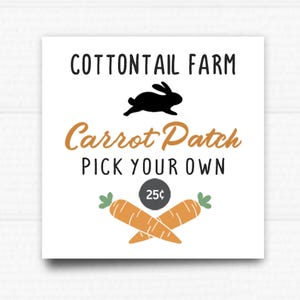 May include: A white sign with black text that reads "Cottontail Farm Carrot Patch Pick Your Own 25c". A black silhouette of a rabbit is above the text. Two orange carrots with green tops are crossed below the text.