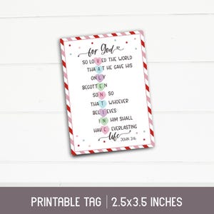 May include: Printable tag with a red and white striped border. The tag features a pink, green, and blue heart design with the text "for God" and a Bible verse: "For God so loved the world, that he gave his only begotten Son, that whoever believes in him shall have everlasting life. John 3:16."
