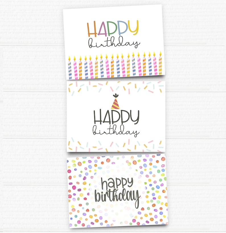 May include: Three printable birthday cards with different designs. The first card has a row of colorful candles with the text "HAPPY birthday". The second card has a party hat and the text "HAPPY birthday". The third card has a colorful confetti pattern and the text "happy birthday".