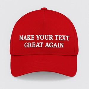 May include: A red baseball cap with white embroidered text reading "MAKE YOUR TEXT GREAT AGAIN". The cap features a curved peak and a button on top. This hat is a statement piece.