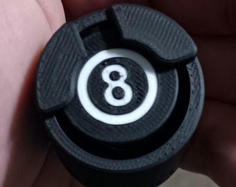 May include: Black and white 8-ball pool cue tip with a textured surface.