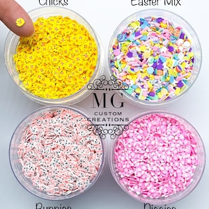 May include: Four clear jars filled with colorful Easter-themed sprinkles. The jars are labeled "Chicks", "Easter Mix", "Bunnies", and "Piggies".